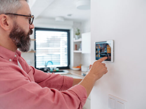 homeowner using his thermostat